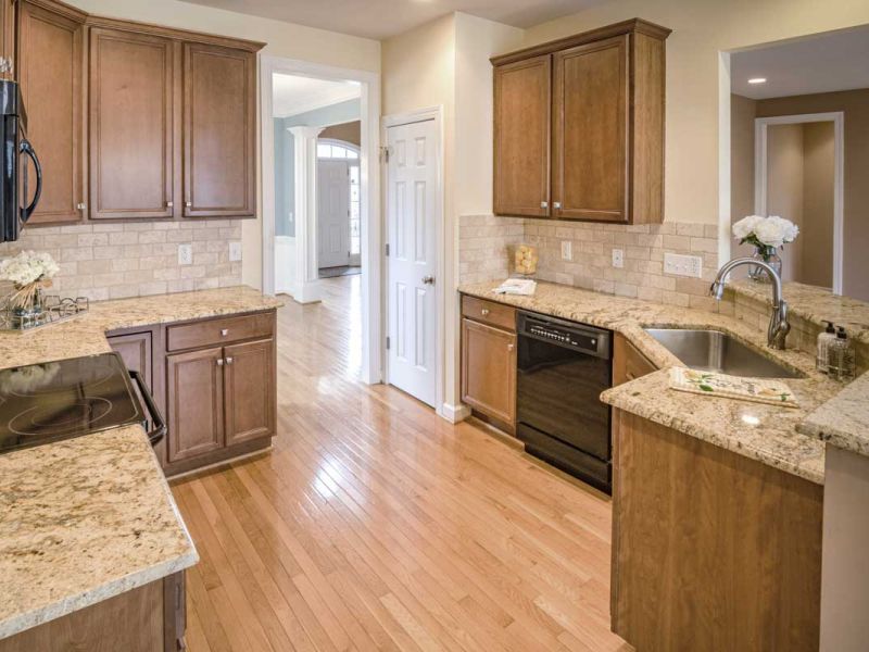 Kitchen featuring a natural brown granite countettops.