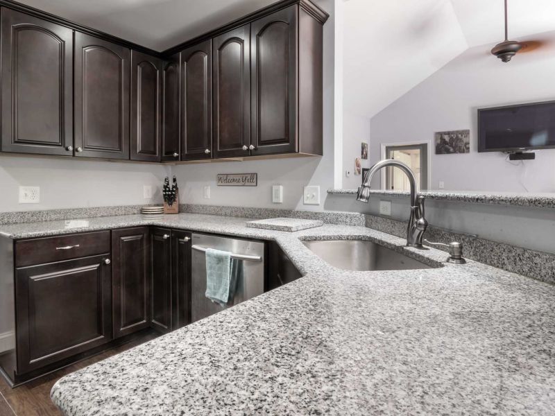 Newly renovated kitchen with granite countertop and inset sink.