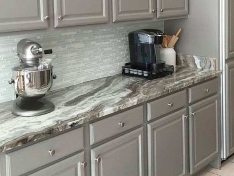 Kitchen countertop with heavy marble with grey lines mixed with white.