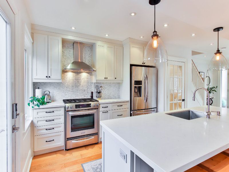 Kitchen renovations included a white engineered stone countertop.