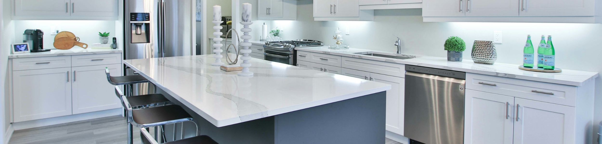 This kitchen features a very light marble countertop with light colored bands.